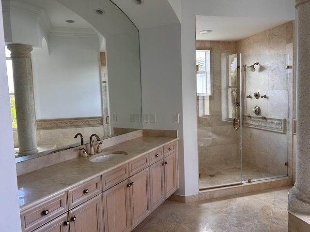 full bath with vanity, ornamental molding, a shower stall, and decorative columns