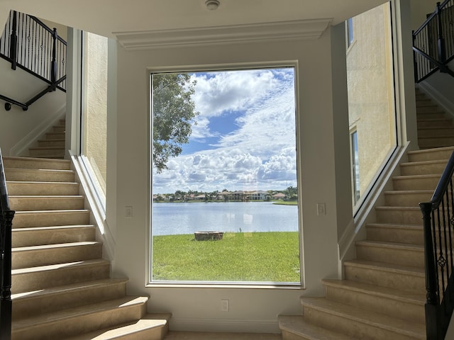 staircase featuring plenty of natural light and a water view