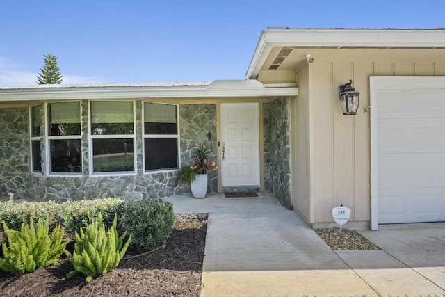 doorway to property featuring stone siding