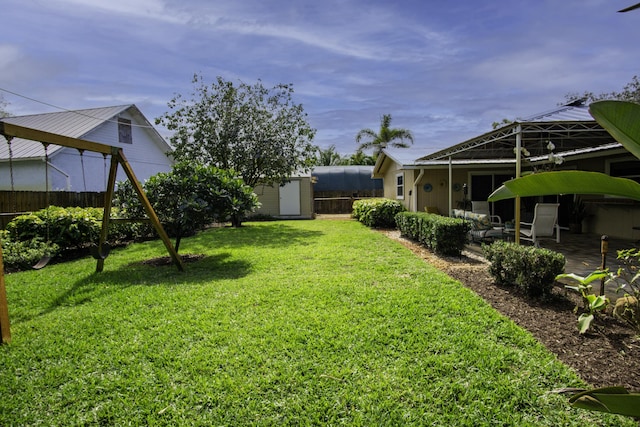 view of yard with a patio, a shed, an outdoor structure, and fence