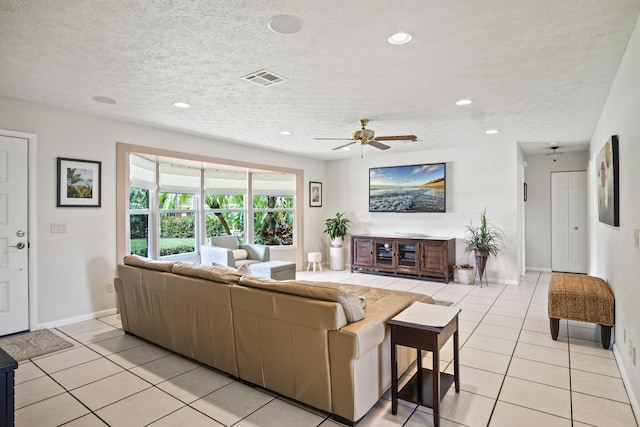 living room featuring recessed lighting, light tile patterned flooring, visible vents, and a textured ceiling