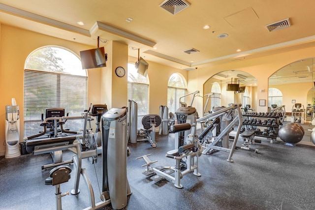 workout area featuring ornamental molding, recessed lighting, and visible vents