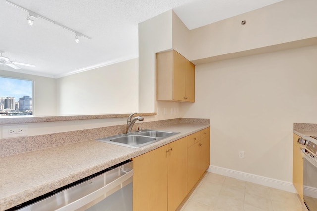 kitchen with stainless steel dishwasher, ceiling fan, light countertops, and a sink