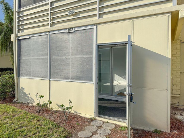 property entrance featuring stucco siding