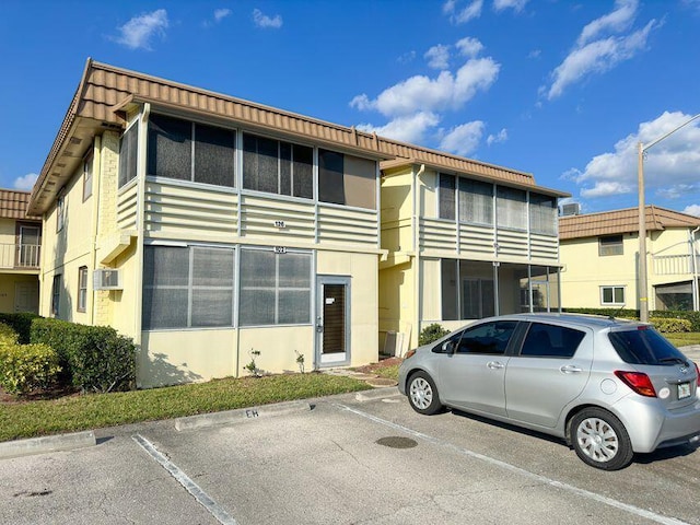 view of building exterior with uncovered parking