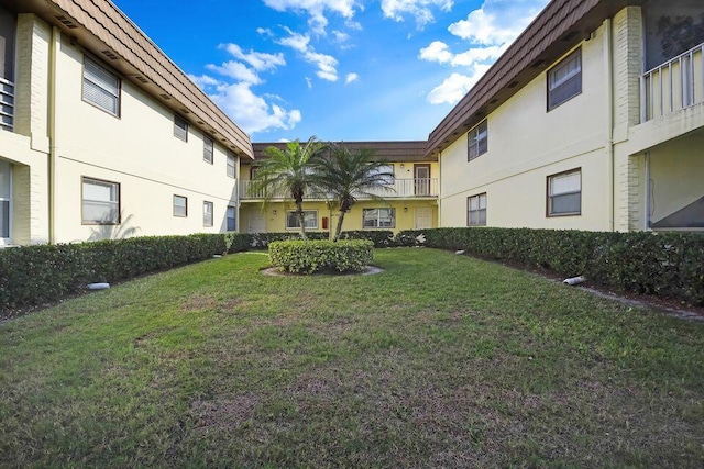 view of home's community with a lawn