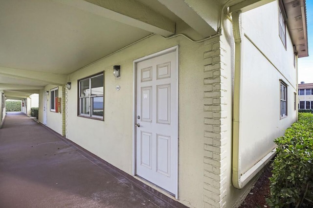 entrance to property with stucco siding