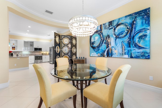 dining room featuring crown molding, light tile patterned floors, visible vents, an inviting chandelier, and baseboards