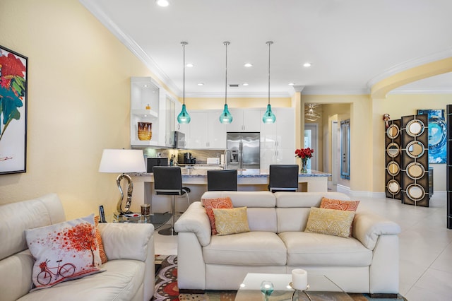 living room with light tile patterned floors, ornamental molding, and recessed lighting