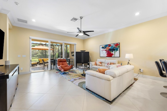 living room featuring visible vents, ornamental molding, a ceiling fan, light tile patterned flooring, and baseboards