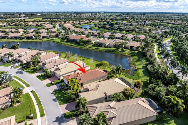 drone / aerial view with a water view and a residential view