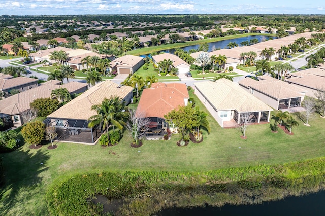 drone / aerial view with a water view and a residential view