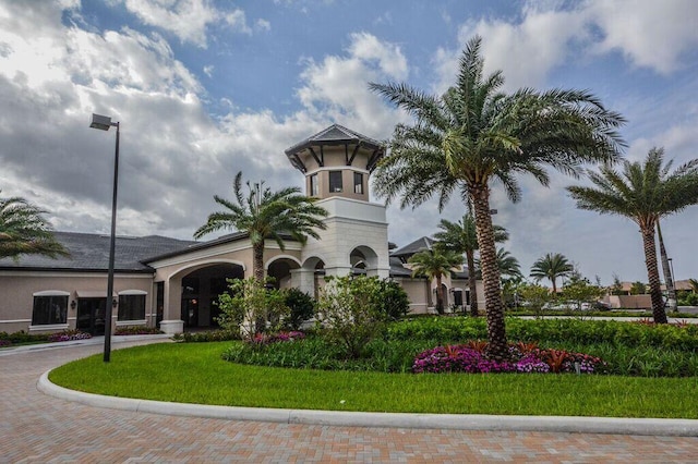 view of property featuring decorative driveway