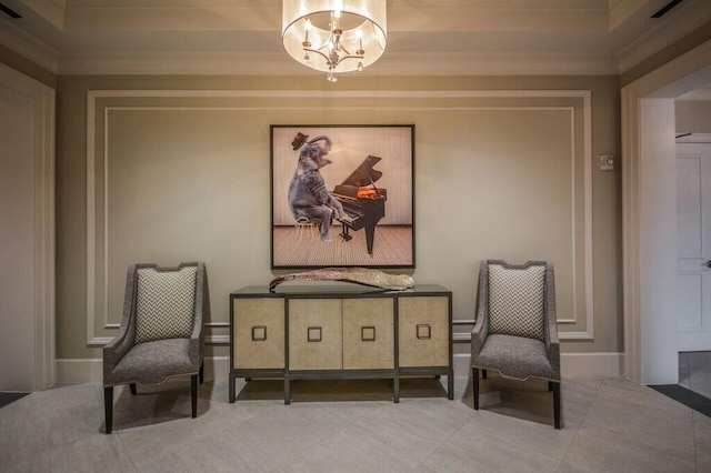 sitting room featuring tile patterned floors, baseboards, a chandelier, and ornamental molding