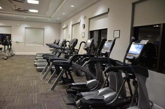 exercise room with carpet floors, baseboards, a tray ceiling, and recessed lighting