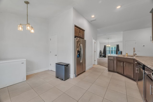 5361 San Benedetto Pl, Fort Pierce, FL 34951 - kitchen with light tile patterned floors, appliances with stainless steel finishes, hanging light fixtures, a chandelier, and a sink