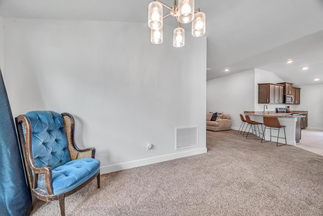 5361 San Benedetto Pl, Fort Pierce, FL 34951 - sitting room with lofted ceiling, light carpet, visible vents, baseboards, and an inviting chandelier