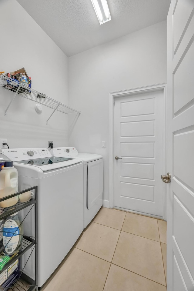 5361 San Benedetto Pl, Fort Pierce, FL 34951 - clothes washing area featuring laundry area, independent washer and dryer, a textured ceiling, and light tile patterned floors