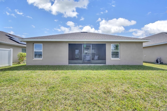 5361 San Benedetto Pl, Fort Pierce, FL 34951 - rear view of property featuring a sunroom, roof with shingles, a lawn, and stucco siding