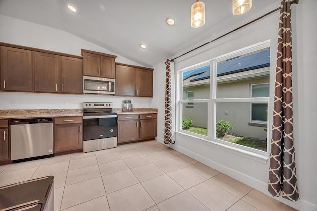 5361 San Benedetto Pl, Fort Pierce, FL 34951 - kitchen with lofted ceiling, light tile patterned floors, recessed lighting, baseboards, and appliances with stainless steel finishes