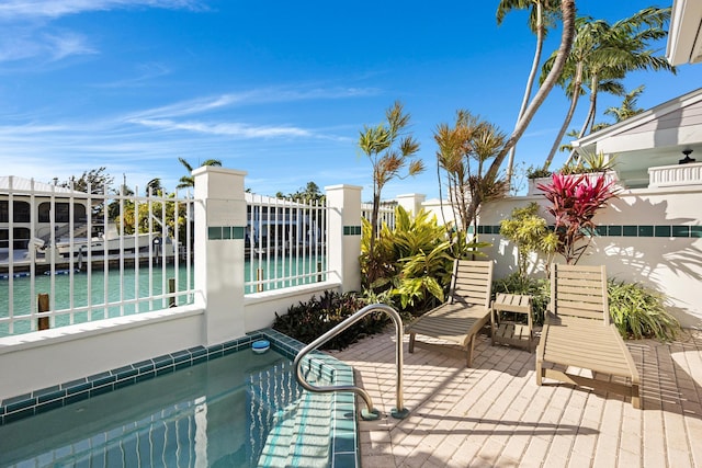 exterior space with a water view and fence