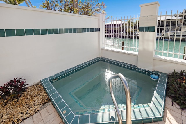 view of pool with an in ground hot tub