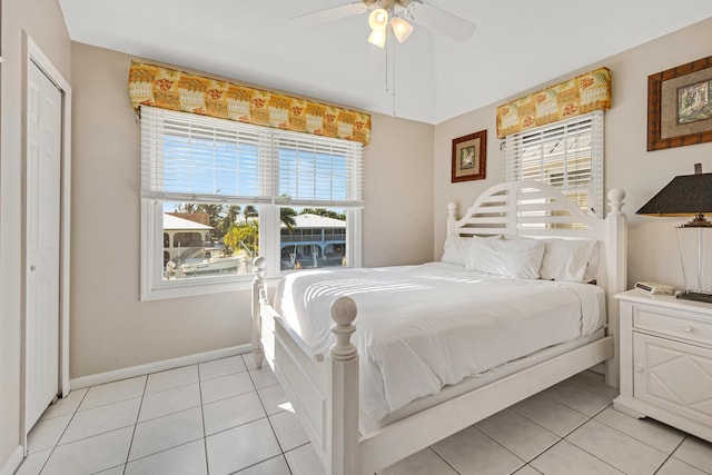 bedroom featuring ceiling fan, baseboards, and light tile patterned floors