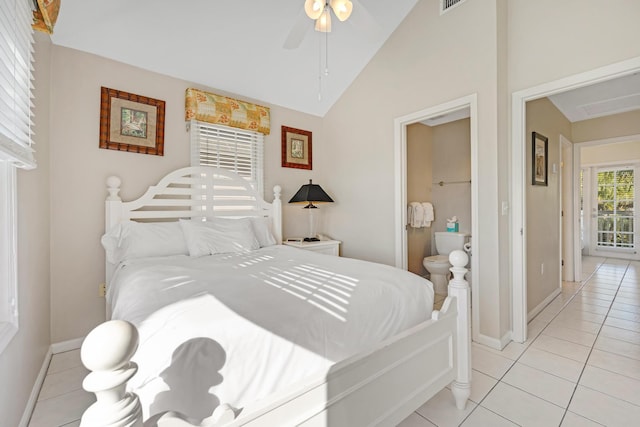 bedroom featuring ceiling fan, light tile patterned flooring, baseboards, vaulted ceiling, and ensuite bath