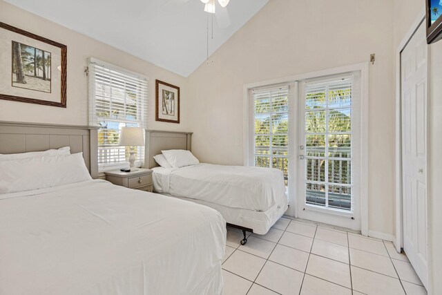 bedroom with ceiling fan, light tile patterned flooring, access to exterior, vaulted ceiling, and french doors