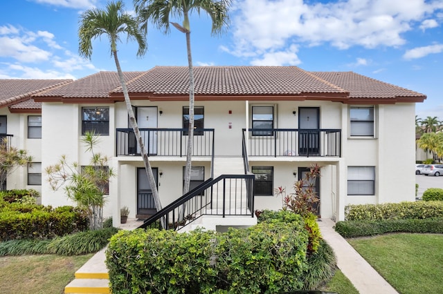 exterior space featuring a tiled roof and stucco siding