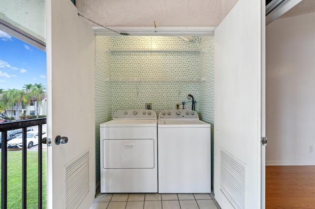 washroom featuring laundry area, visible vents, independent washer and dryer, and light tile patterned floors