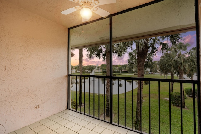 exterior space featuring a water view and a ceiling fan