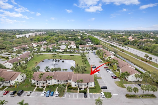 birds eye view of property featuring a water view and a residential view