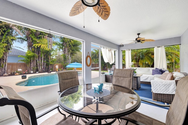 sunroom featuring a ceiling fan