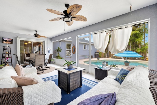 living room with a sunroom and a ceiling fan