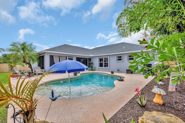 view of swimming pool with a sunroom, fence, a fenced in pool, and a patio