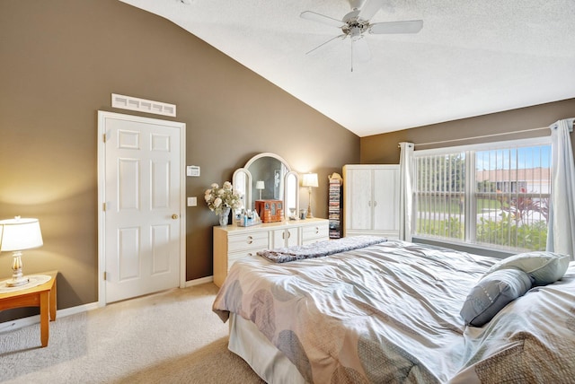 bedroom featuring visible vents, baseboards, light colored carpet, lofted ceiling, and ceiling fan