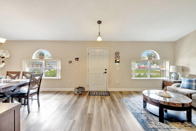 entryway with light wood finished floors and baseboards