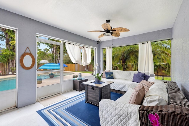 sunroom with a ceiling fan