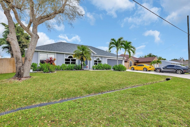 ranch-style house featuring stucco siding, concrete driveway, an attached garage, a front yard, and fence