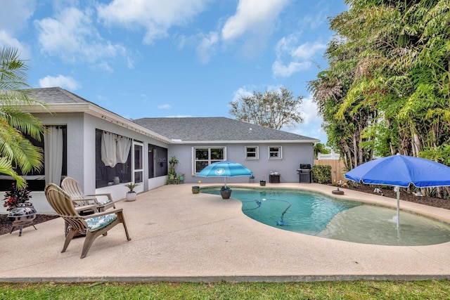 view of pool with area for grilling, fence, a sunroom, a fenced in pool, and a patio area