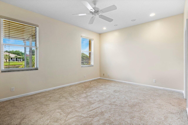 carpeted empty room featuring recessed lighting, baseboards, a textured ceiling, and ceiling fan