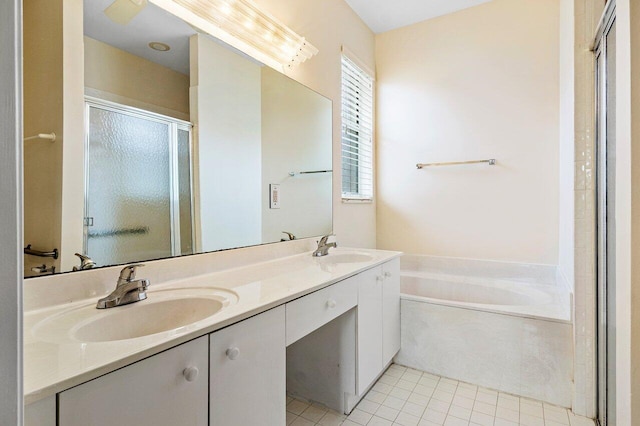 bathroom featuring double vanity, a bath, a stall shower, and a sink