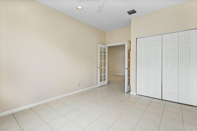 unfurnished bedroom featuring light tile patterned floors, visible vents, baseboards, and french doors