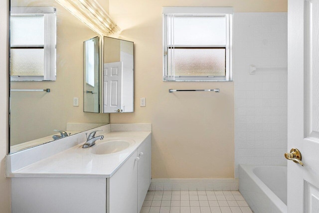 bathroom featuring tile patterned floors, plenty of natural light, vanity, and baseboards