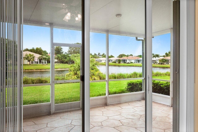 unfurnished sunroom featuring a water view