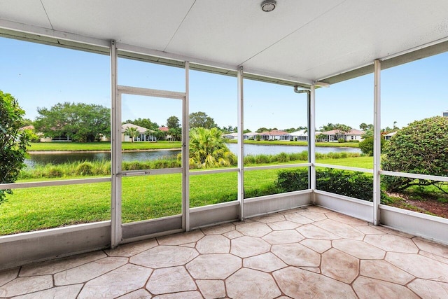 unfurnished sunroom with a water view