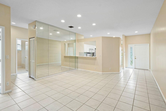 spare room with light tile patterned floors, visible vents, baseboards, and recessed lighting