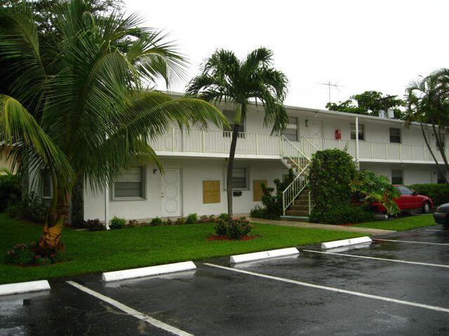 view of building exterior featuring uncovered parking and stairway