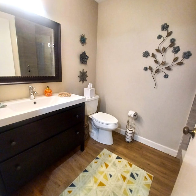 5070 Nesting Way Unit B, Delray Beach, FL 33484 - full bathroom with toilet, a shower with door, wood finished floors, baseboards, and vanity